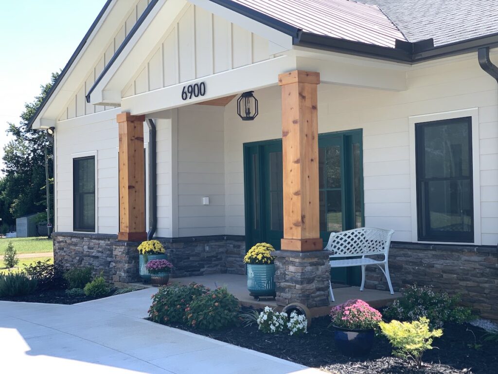 Glen Haven Huntersville assisted living front porch entrance white bench flower planters